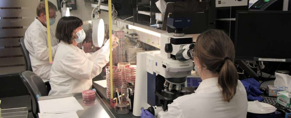 People wearing white lab coats perf