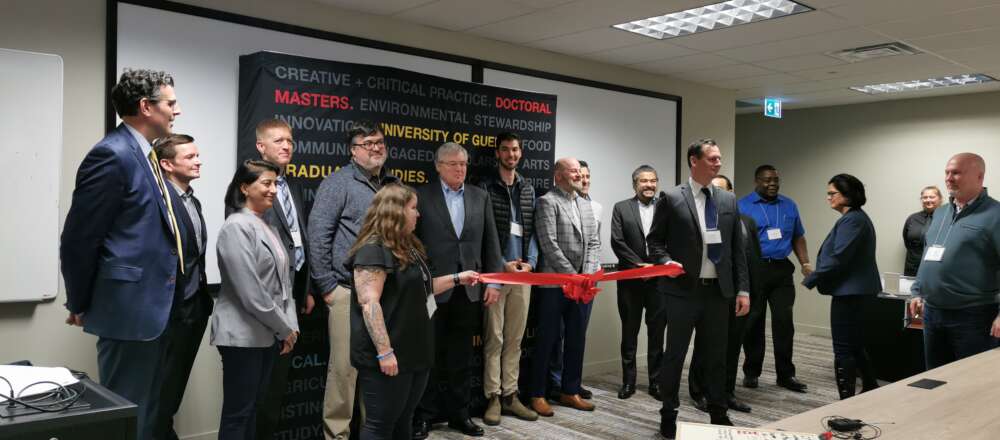 Attendees hold the ceremonial red ribbon at the opening of the MCTI cyber space.