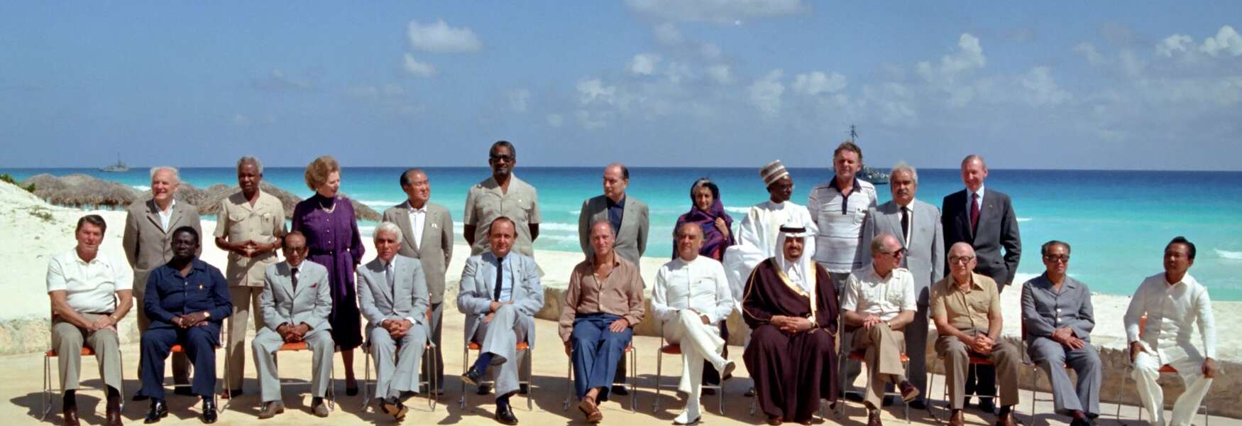 Twenty-one Heads of state and government pose for a photo on a beach in Cancun