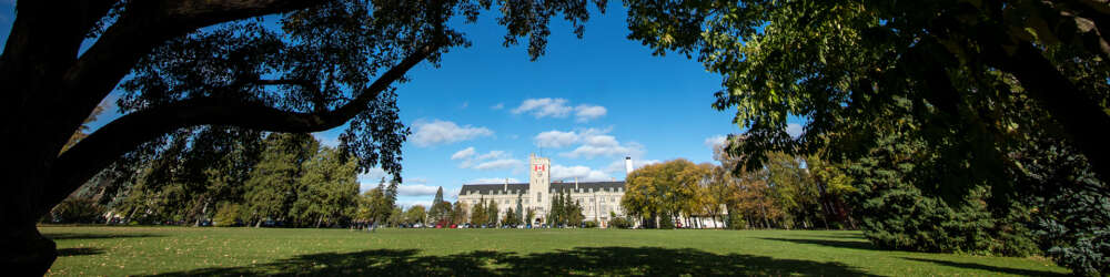 A wide view of Johnston Hall and the green field before it