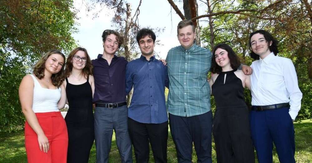 A group of seven incoming U of G students stand with their arms around one another smiling for the camera.