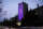 The tall tower of Johnston Hall on the U of G campus is shown in the evening, lit in purple