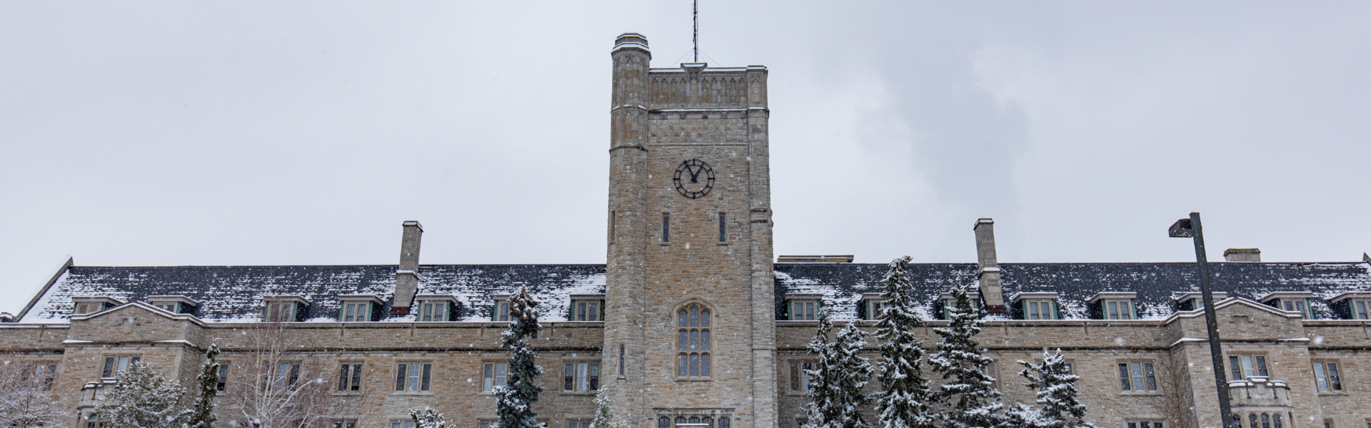 Johnston Hall against a cloudy sky on a snowy day.