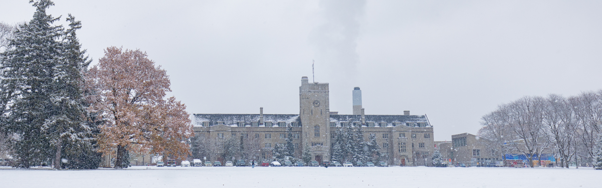 View of Johnston Hall across Johnston Green on a snowy, cloudy day.