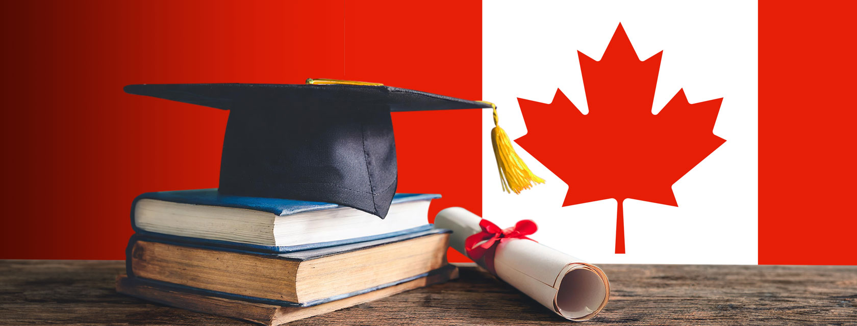 graduation cap sitting on top of pile of books in front of Canadian flag
