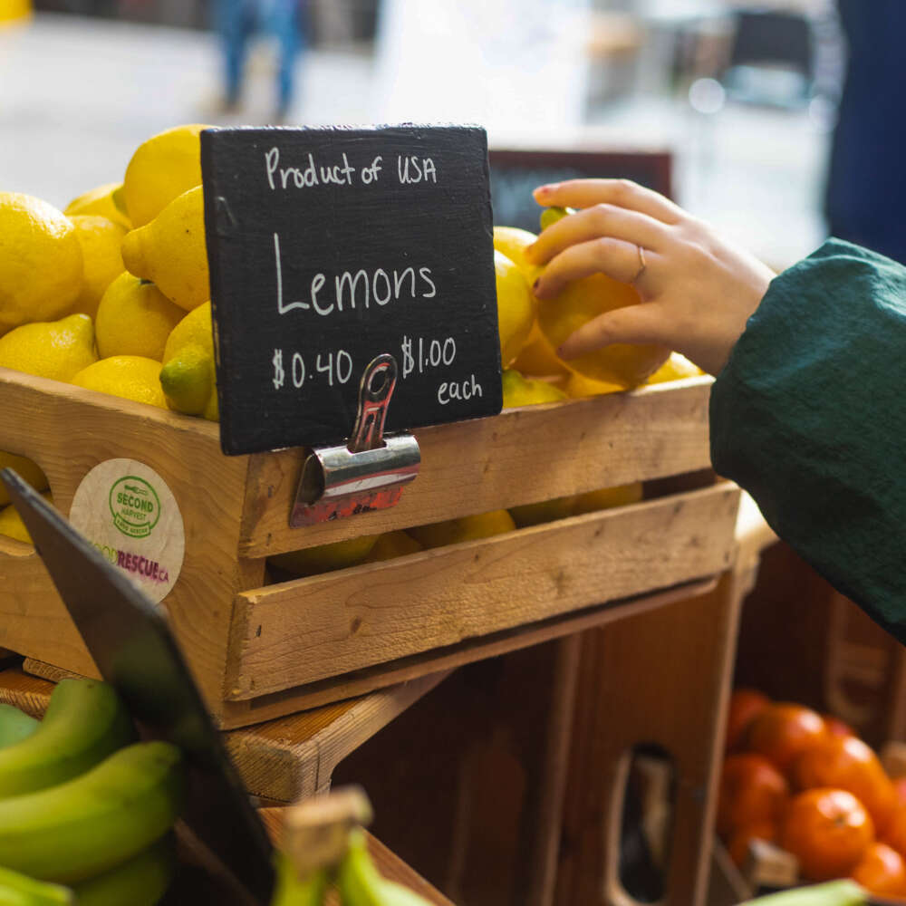 A person reaches for a lemon at the U of G Food Market.