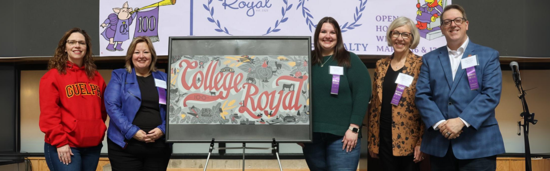 Five people pose for a photo while standing next to a easel showing a depiction of the planned College Royal mural