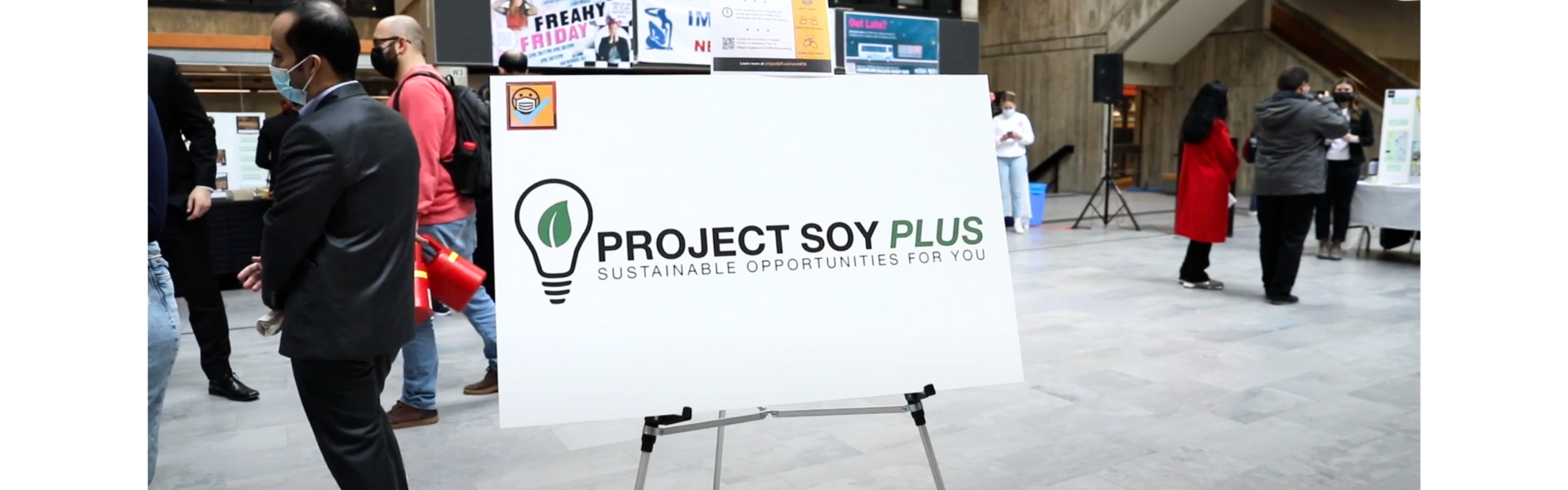 Welcoming banner on stand against the University Centre background, labelled "Project SOY Plus"