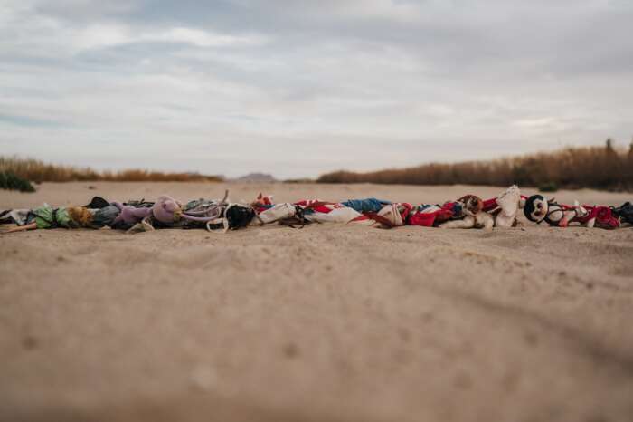 Monica Lozano, The Cemetery, 2022, digital photograph portraying a line of belongings in an arid flat field.