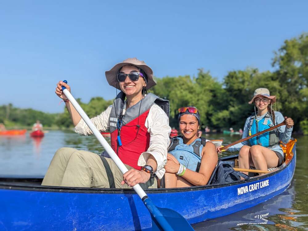 Three canoeists pose for photo