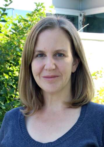 a person poses for a portrait outdoors