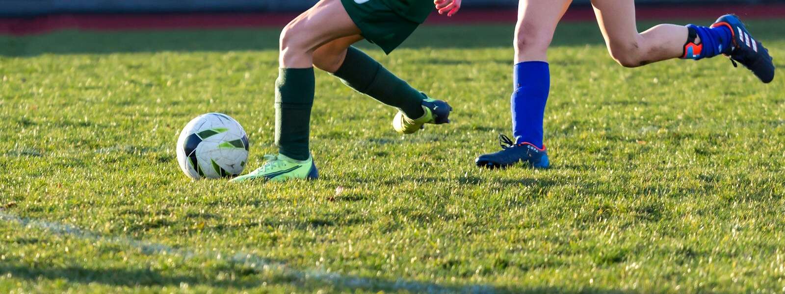 a couple of kids playing a game of soccer