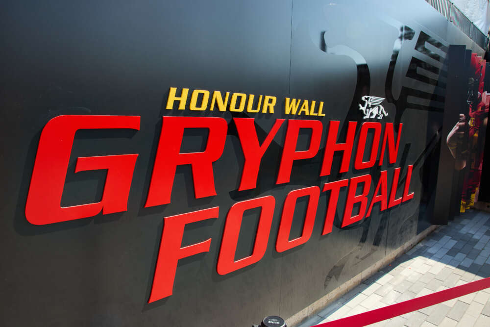 The honour wall, which says Honour Wall Gryphon Football in big letters on a black shiny wall.