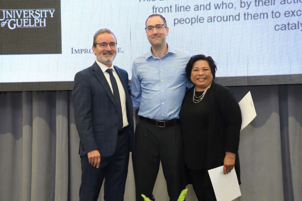 Nick Anbeek poses with his award, Rene Van Acker and Jovita De La Torre.