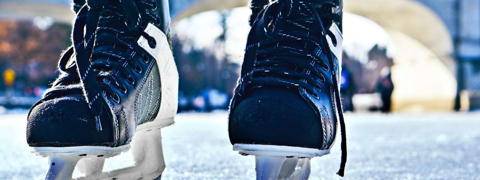 close-up photo of black-and-gray Intruder ice skates on frozen body of water