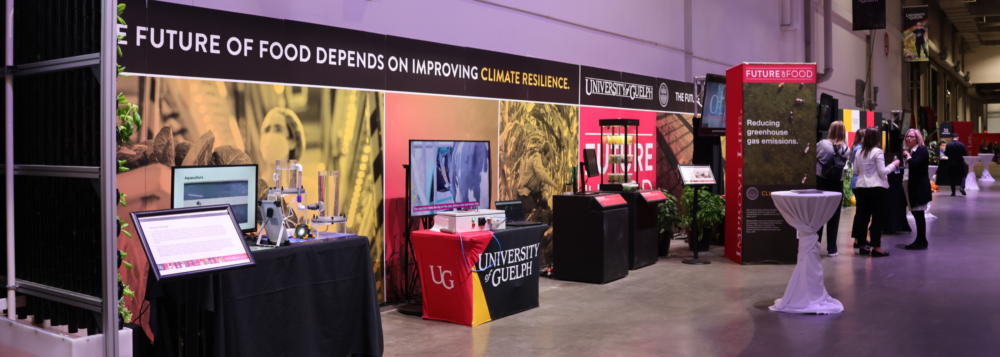 A hallway with U of G's exhibit at the Royal Agricultural Fair, with signs reading The Future of Food Depends on Improving Climate Resilience