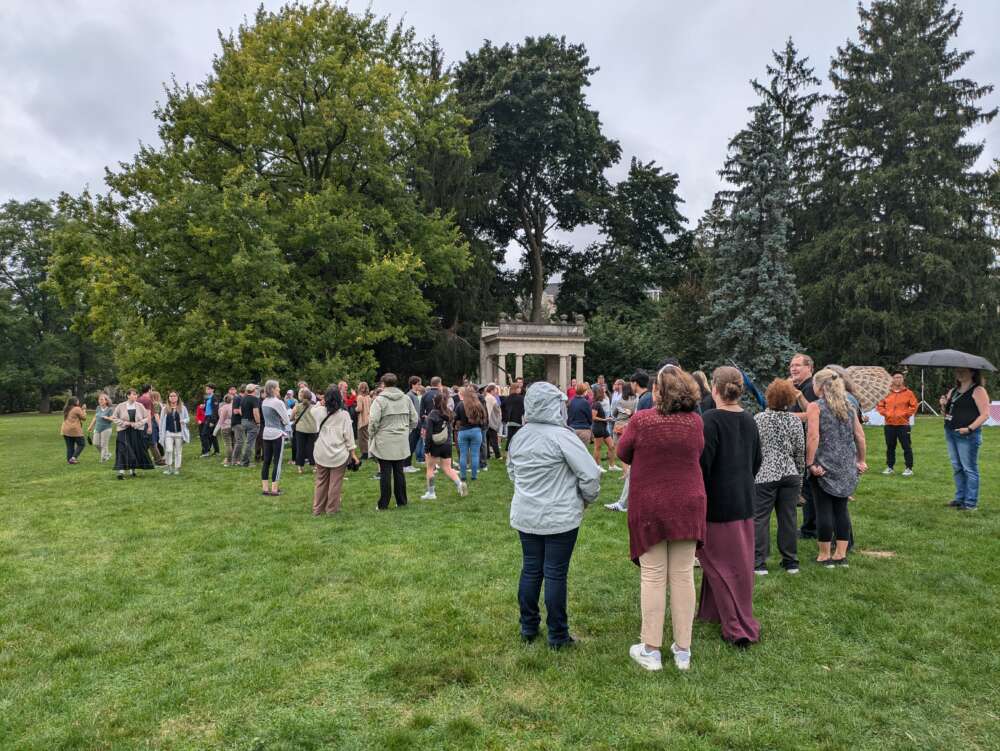 People stand around socializing on Johnston Green.