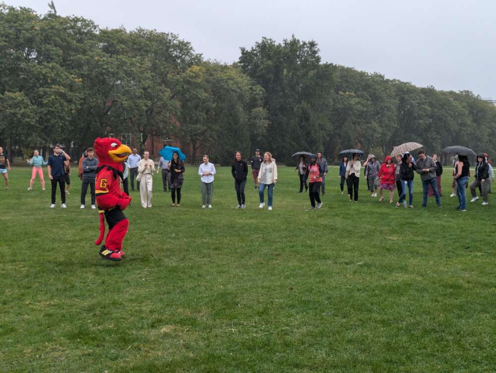 Gryph leads staff and faculty in warm-up exercises.