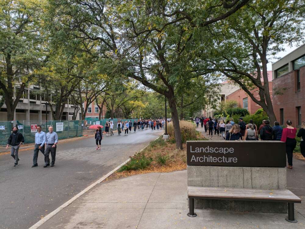 Staff and faculty walk down the path near Landscape Architecture.