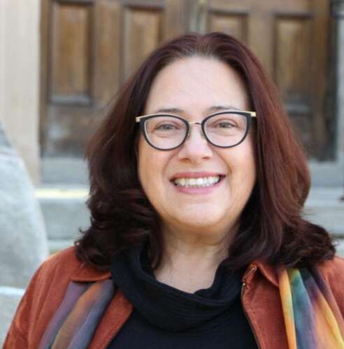 Dr. Dominique Charron poses for a photo outside on the OVC building steps