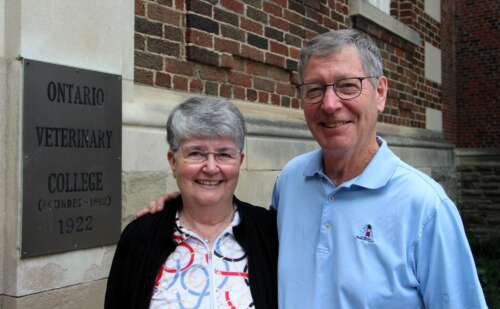 Sheryl and David Kerr near a sign that reads Ontario Veterinary College