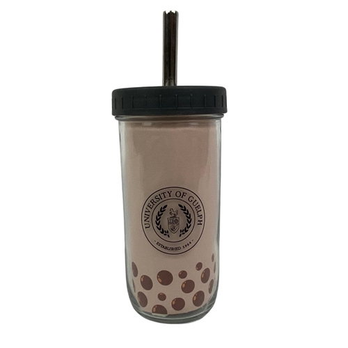 A glass bubble tea cup full of bubble tea with boba.