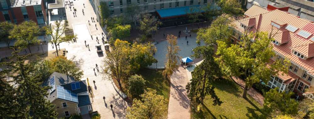 an overhead shot of the university of guelph campus showing students walking on a path and trees