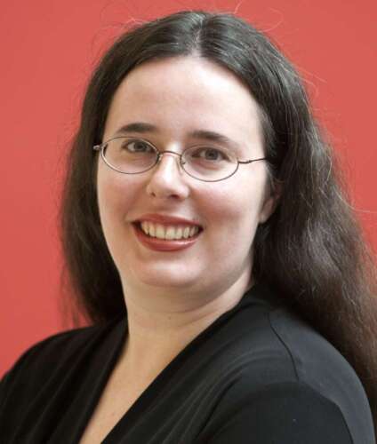 Dr. Laurie Barclay in black, wearing glasses against red background.