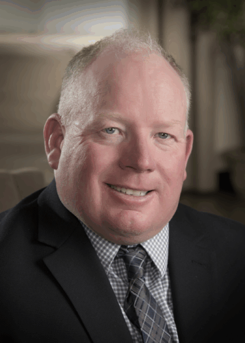 Headshot of Jeff Harrison facing the camera and wearing a suit and tie