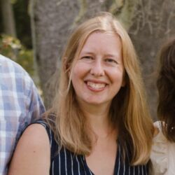 a person poses for a photo outside