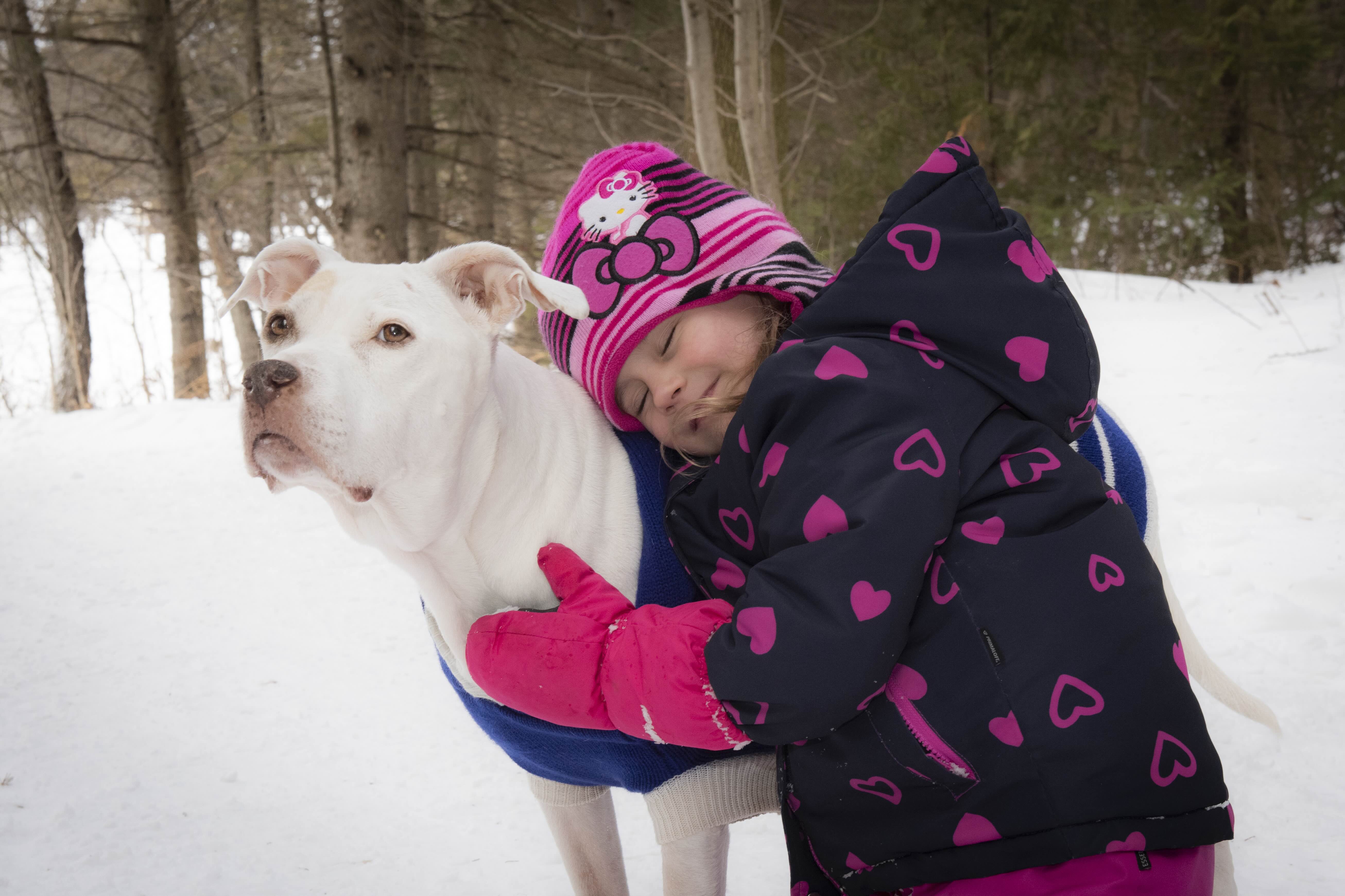 Sydney embraces her dog Bella 