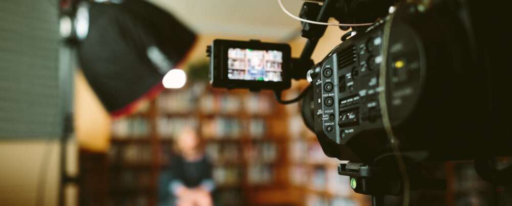 person sitting in front bookshelf