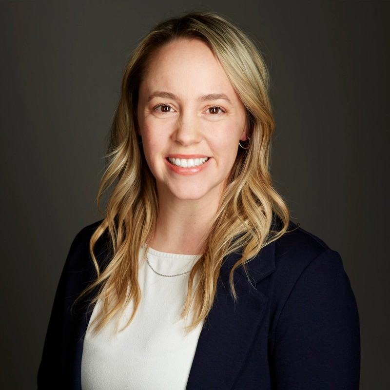 Danielle Bentley smiles against a black background