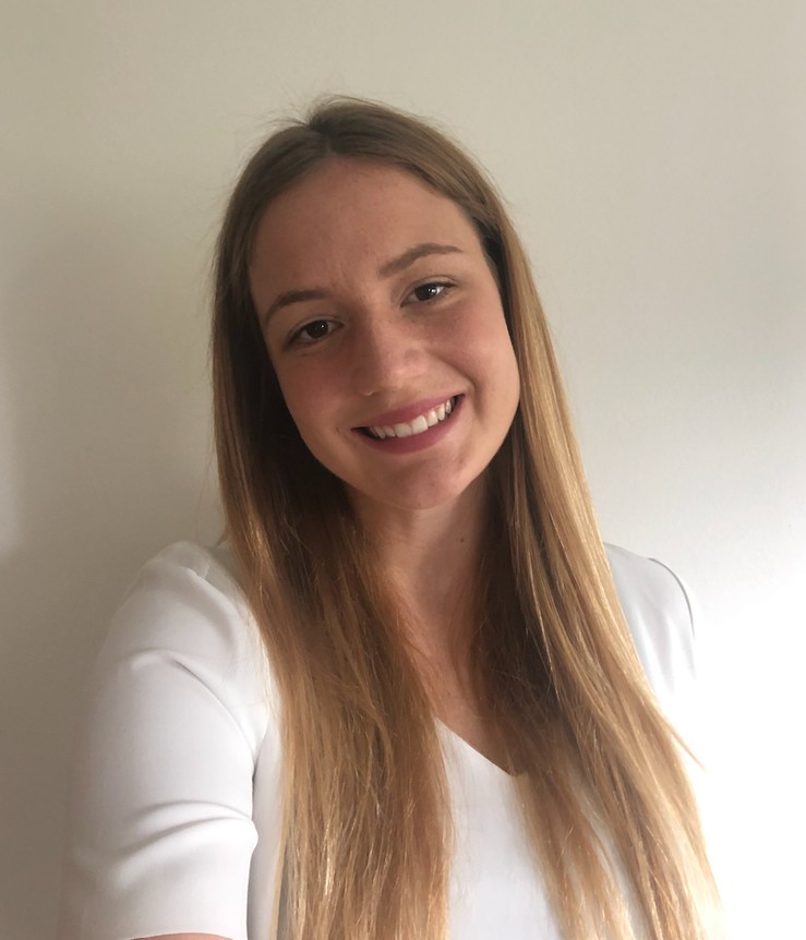 a person with long hair poses for a headshot