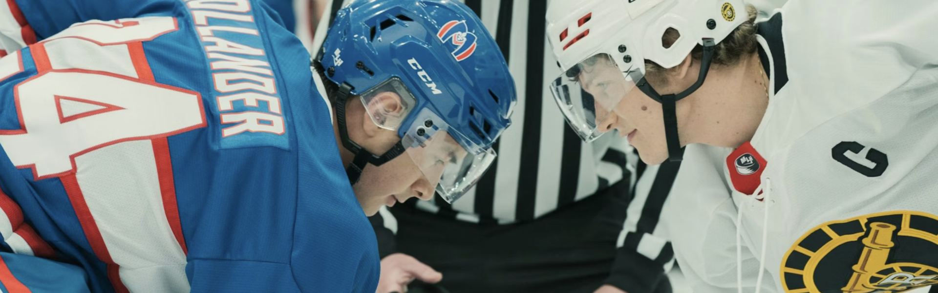 two hockey players in jerseys and helmets face off