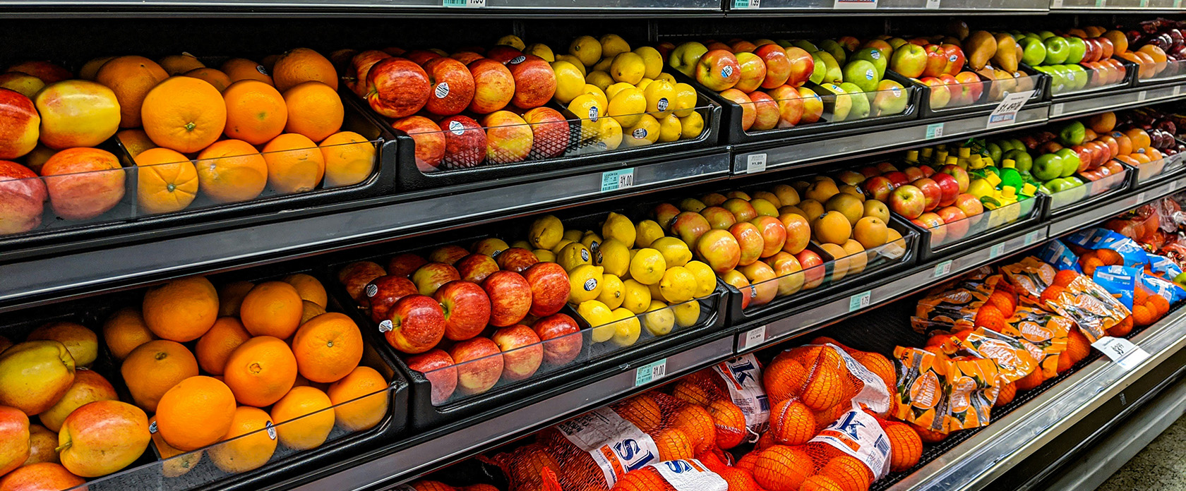various fruits in the produce section of a grocery store