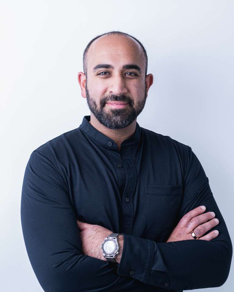 person wearing a black shirt poses for a headshot