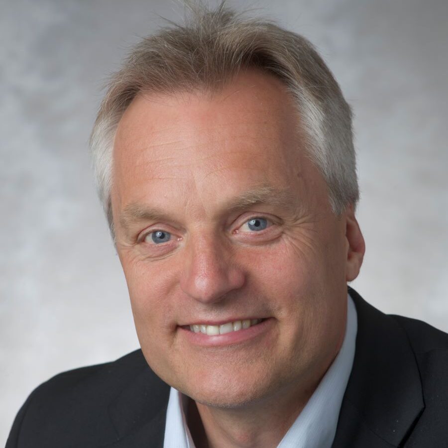 Dr. Alfons Weersink in front of a grey backdrop