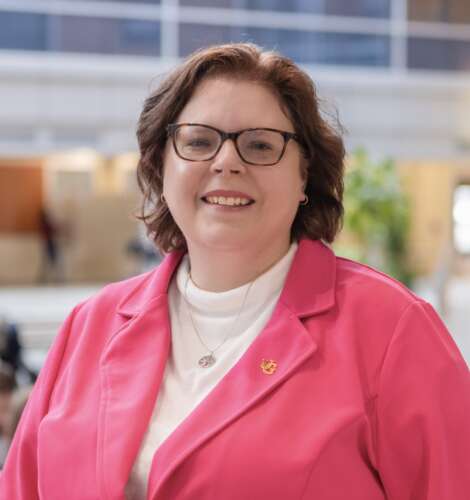 Headshot of Dr. Stacey Scott, wearing a pink blazer and smiling at the camera.