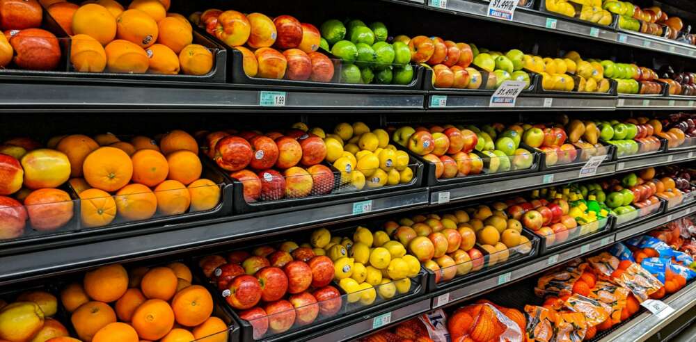 yellow and red apples on black plastic crate