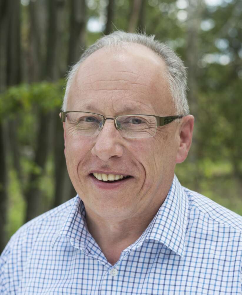 Headshot of Peter Conlon, wearing a blue checked shirt