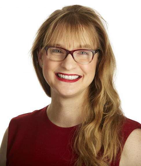 Headshot of Kim Francis, wearing a red sleeveless top.