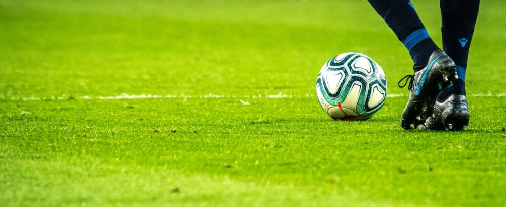 man playing soccer game on field