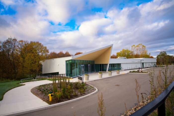 Honey Bee Research Centre exterior. The roof has a large pointed awning and there are large glass windows.