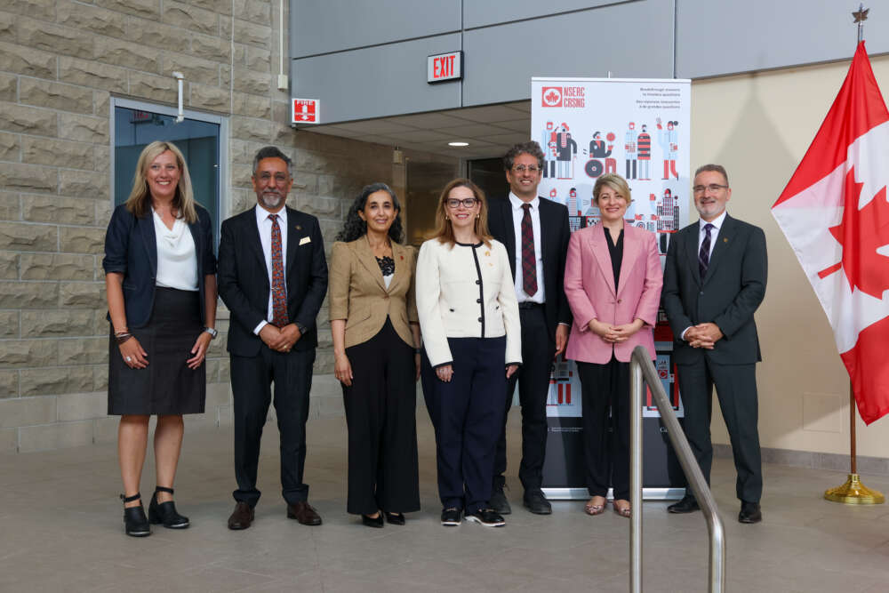 seven people stand for a group photo