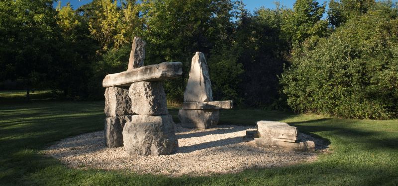 An outdoor sculpture of large rocks stacked.