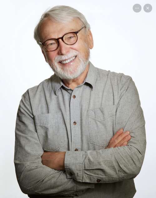 Headshot of Werner Zimmerman, with arms crossed and smiling.