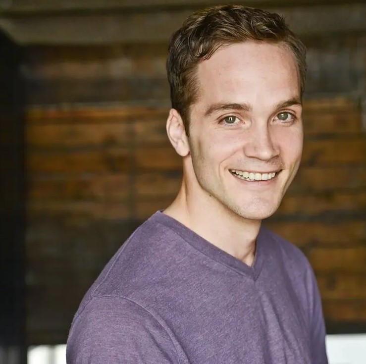 person in t shirt poses for head shot