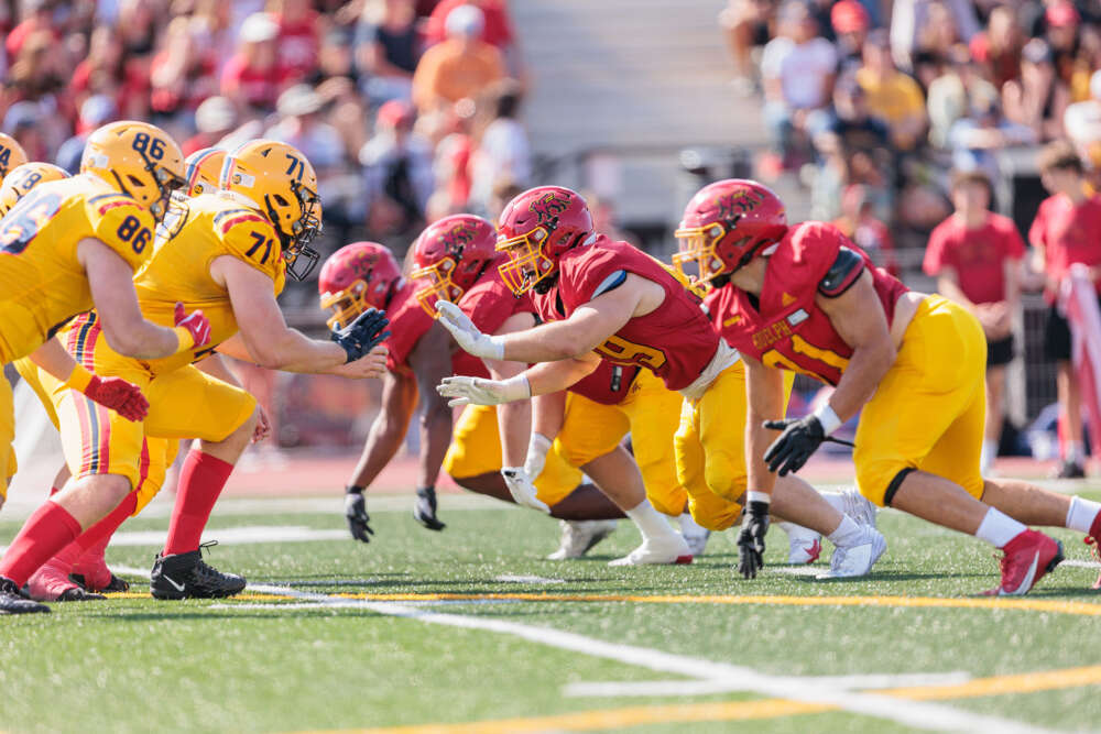 student football players line up on turf