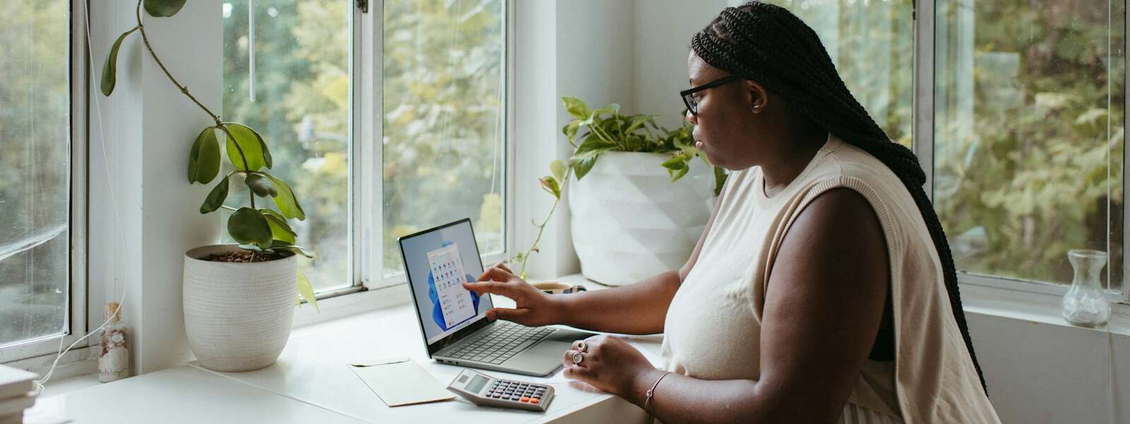 a woman sitting at a table with a laptop